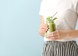 Lady holding green smoothie