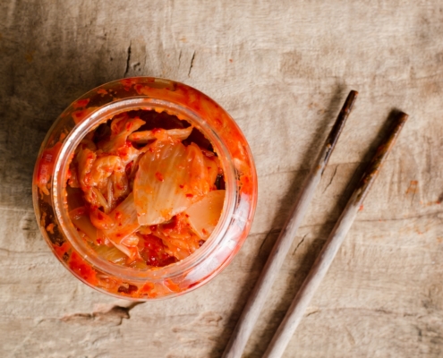 jar of homemade kimchi and chopsticks